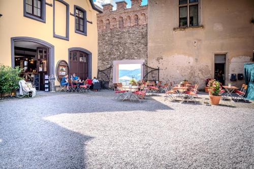 a group of tables and chairs outside of a building at Schloss Arenfels in Bad Hönningen