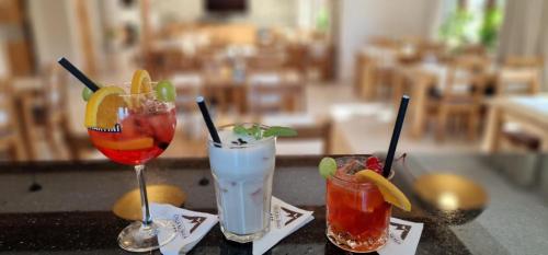 two cocktails sitting on a table with at Orlicka Skała in Zieleniec