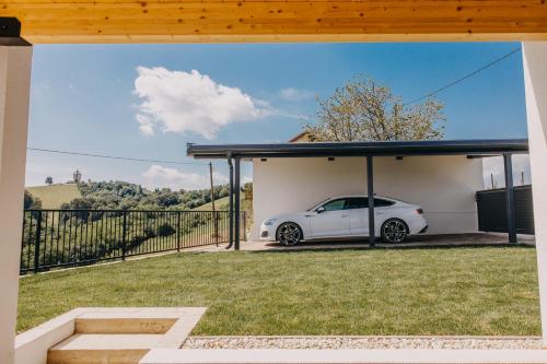 a white car parked under a garage at Novak Home in Štrigova