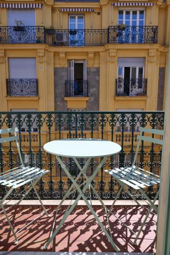 a table and two chairs on a balcony at Aparthotel 9 ALBERTI Nice Centre in Nice