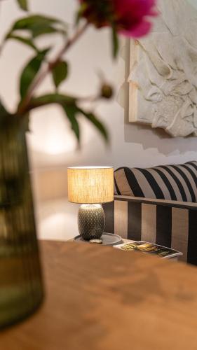 a lamp sitting on a table next to a chair at Up de Schüün - Design Studio in Meißendorf