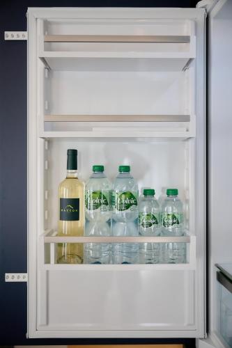 a refrigerator filled with lots of bottles of alcohol at Aparthotel 9 ALBERTI Nice Centre in Nice
