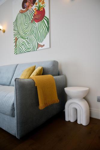 a living room with a gray couch and a table at Aparthotel 9 ALBERTI Nice Centre in Nice