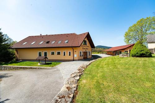 a large house with a road leading to it at Penzion Šejby in Horní Stropnice