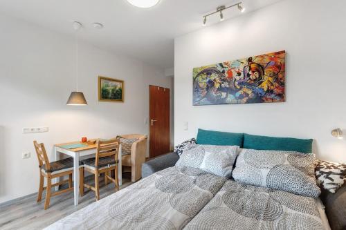 a bedroom with a bed and a table and a dining room at Ferienwohnung Sonnenblick in Bad Berleburg