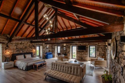 a bedroom with a bed and a stone wall at Open Space com Jacuzzi a 5 mn do centro de Lamego in Lamego