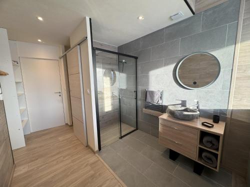 a bathroom with a sink and a mirror at Artik chalet avec vue à 180 degrés et piscine in Les Angles