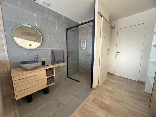 a bathroom with a sink and a mirror at Artik chalet avec vue à 180 degrés et piscine in Les Angles