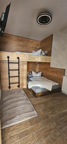 a bedroom with a bed with a wooden wall at Home sweet Home in Havelberg