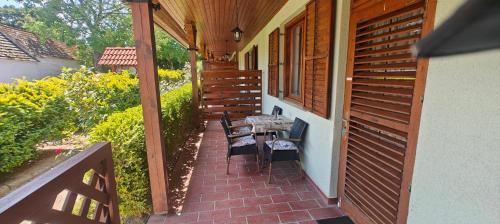 a porch with a table and chairs on a house at Aurora Ház in Zalakaros