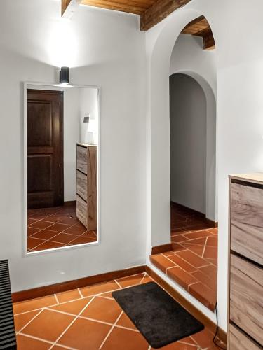 a bathroom with a mirror and a tile floor at Villa Verde splendida villa con piscina - Stintino Sardegna in Cuile Pazzoni