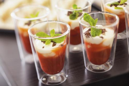 a group of glasses filled with different types of dessert at Mövenpick Hotel München-Airport in Hallbergmoos