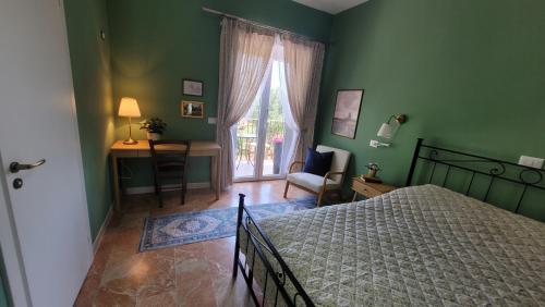 a bedroom with a bed and a desk and a window at Villa MaVi Guesthouse in Maenza