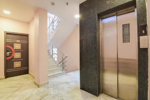 a elevator in a building with a staircase at Super Collection O Park Circus in Kolkata