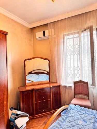a bedroom with a mirror on a dresser and a bed at Villa Kosmopoliten in K'obulet'i