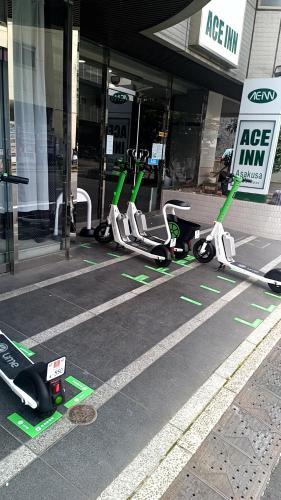 a row of scooters parked in front of a building at Ace Inn Asakusa in Tokyo