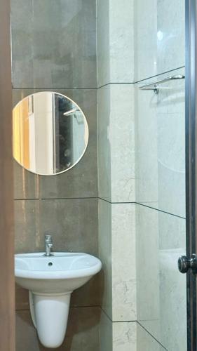 a bathroom with a sink and a mirror at Nestora Suites in Kozhikode