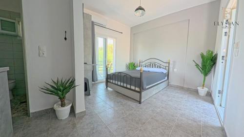 a bedroom with a bed and two potted plants at Double Suite 1ST FLOOR N4 in Flogita