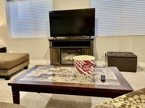 a living room with a coffee table and a tv at Charming Provo Home close to BYU and Utah Lake in Provo