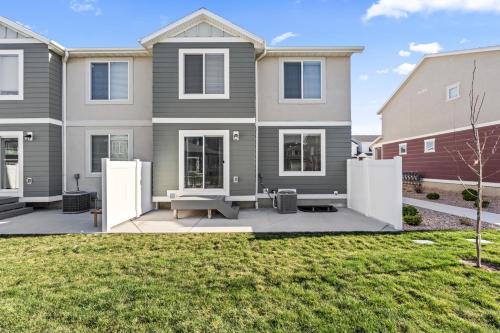 a house with a patio in front of a yard at Modern 3BR Townhome in Lehi UT in Lehi