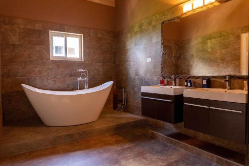 a bathroom with a large tub and two sinks at Seaview Penthouse Retreat 4 Beds 3 Baths Stay in Whitehouse