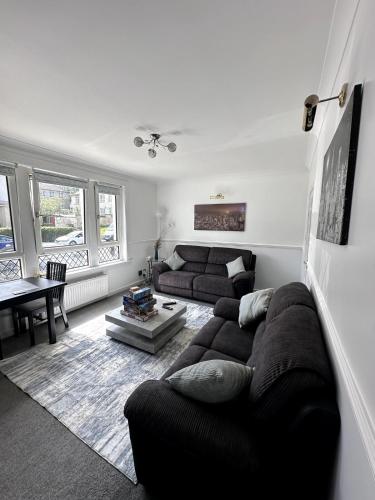 a living room with a couch and a table at Luxury House in Glasgow in Mansewood