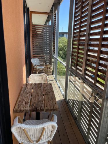 a wooden table and chairs on a balcony at Port of Travemünde, Opening 2021 in Travemünde