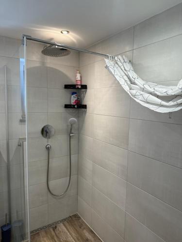 a bathroom with a shower with a shower curtain at Schöne EG Wohnung in Kolbermoor