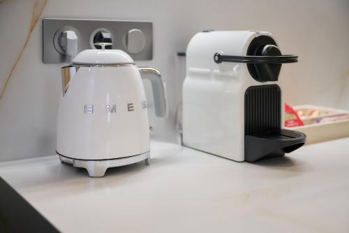 a coffee maker sitting on a kitchen counter next to a coffee pot at Aparthotel 9 ALBERTI Nice Centre in Nice
