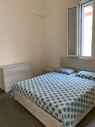 a bedroom with a large bed with a window at Casa Giovannina in Tuglie