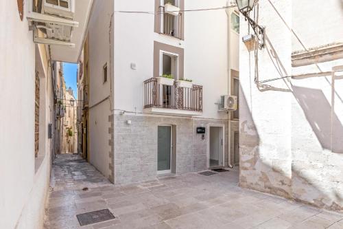 a street in the city with white buildings at Palazzo Seculari by BarbarHouse in Rutigliano