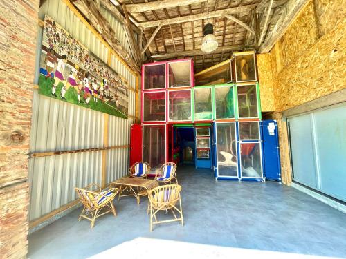 a room with chairs and a table in a building at " Ô Chai Nous " 14 pers - Billard, Babyfoot - Structure de Jeux in Poucharramet