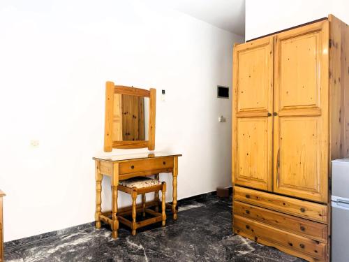 a kitchen with a wooden desk and a cabinet at Lenitsa Central Parga Rooms in Parga