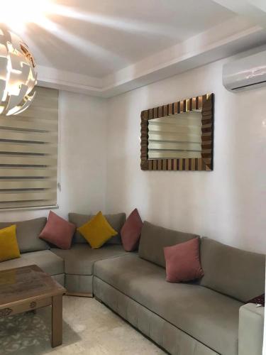 a living room with a couch with colorful pillows at Salam Beach in Pont Blondin