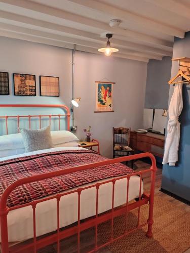 a bedroom with a large bed in a room at Grain Store Cottage in Narberth