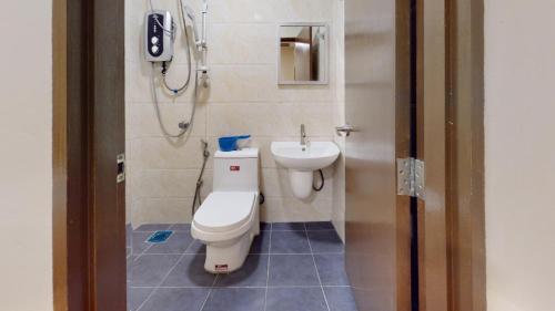 a bathroom with a toilet and a sink at The Pines Hotel in Tanah Rata
