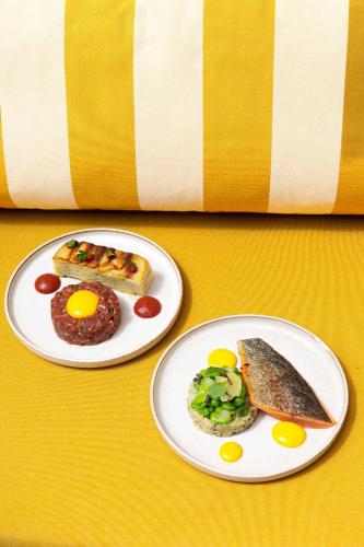 two plates with breakfast foods on them on a table at Bellevigne Bourgogne in Chambolle-Musigny