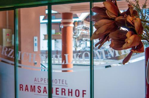 a window with a bunch of flowers in it at Alpenhotel Ramsauerhof in Ramsau im Zillertal