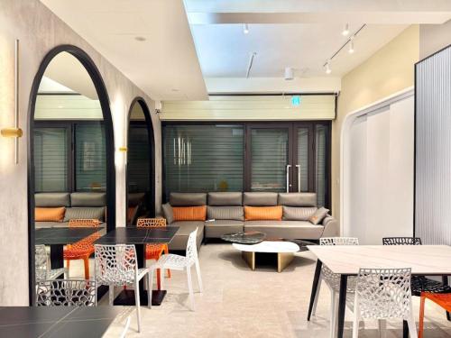 a living room with a couch and tables and chairs at Choozme in Lugang