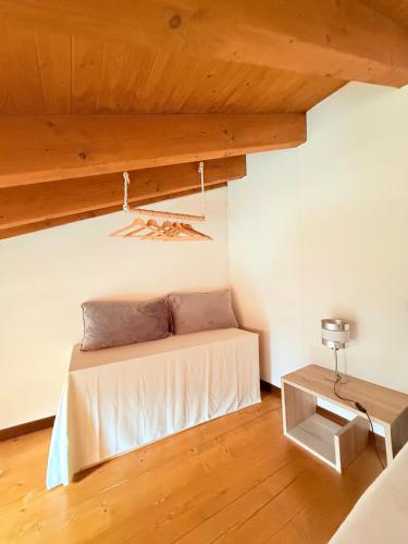 a bed in a room with a wooden ceiling at Gritti Palace Morcote - Vaniglia in Morcote
