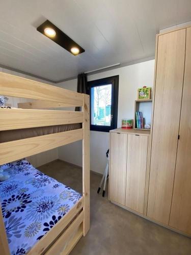 a bedroom with two bunk beds and a window at Gite "Au Père Peinard" in Le Vibal