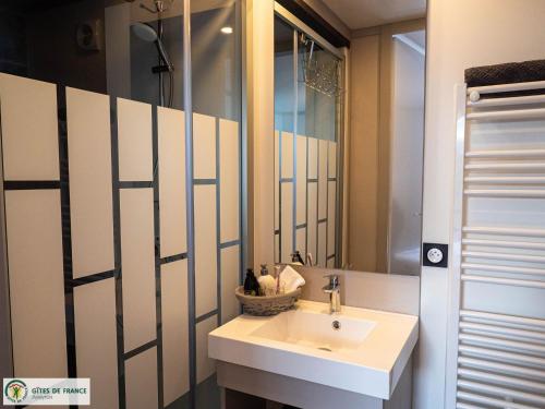 a bathroom with a sink and a mirror at Gite "Au Père Peinard" in Le Vibal