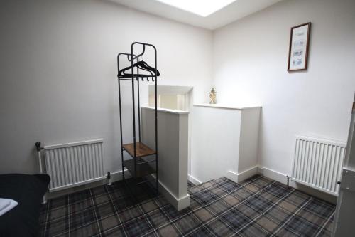 a room with a shelf in the middle of it at Stag View, River Black Water Holiday Flats, INCHBAE, GARVE, IV232PG in Garve