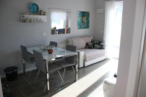a living room with a table and a couch at Residence Il Poggio in Dorio