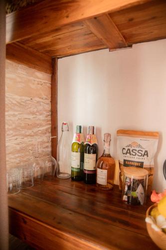 three bottles of wine sitting on a wooden shelf at Les Vagues - Hotel Villa & Beach Club - Gili Air in Gili Air