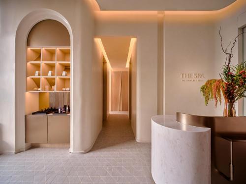 a room with a table and a counter with a shelf at InterContinental Bangkok Sukhumvit by IHG in Bangkok