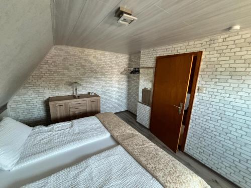 a bedroom with a large bed and a sink at Ferienwohnung Anne in Bremervörde