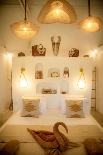 a room with a bed with a swan on it at Les Vagues - Hotel Villa & Beach Club - Gili Air in Gili Air