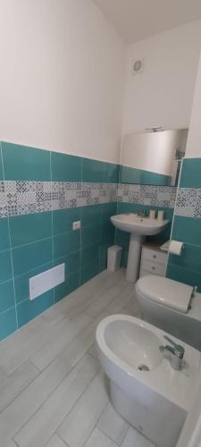 a bathroom with a white sink and a toilet at Affittacamere La Ciprea in San Marco di Castellabate
