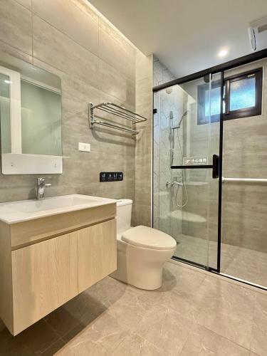 a bathroom with a toilet and a sink and a shower at Choozme in Lugang